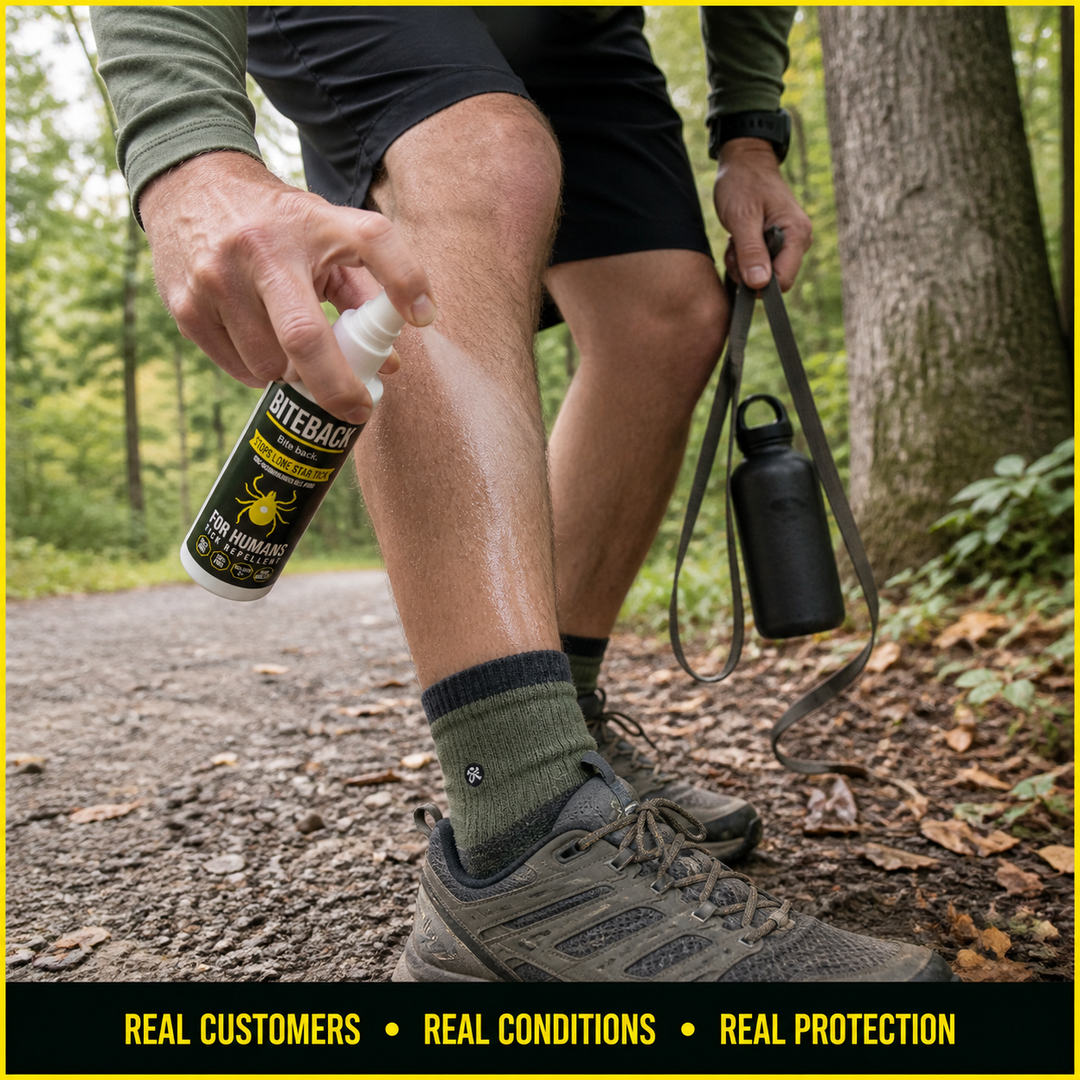 A customer applying BITEBACK Human spray to their ankle on a forest trail — phone-camera UGC style, real customer in real conditions