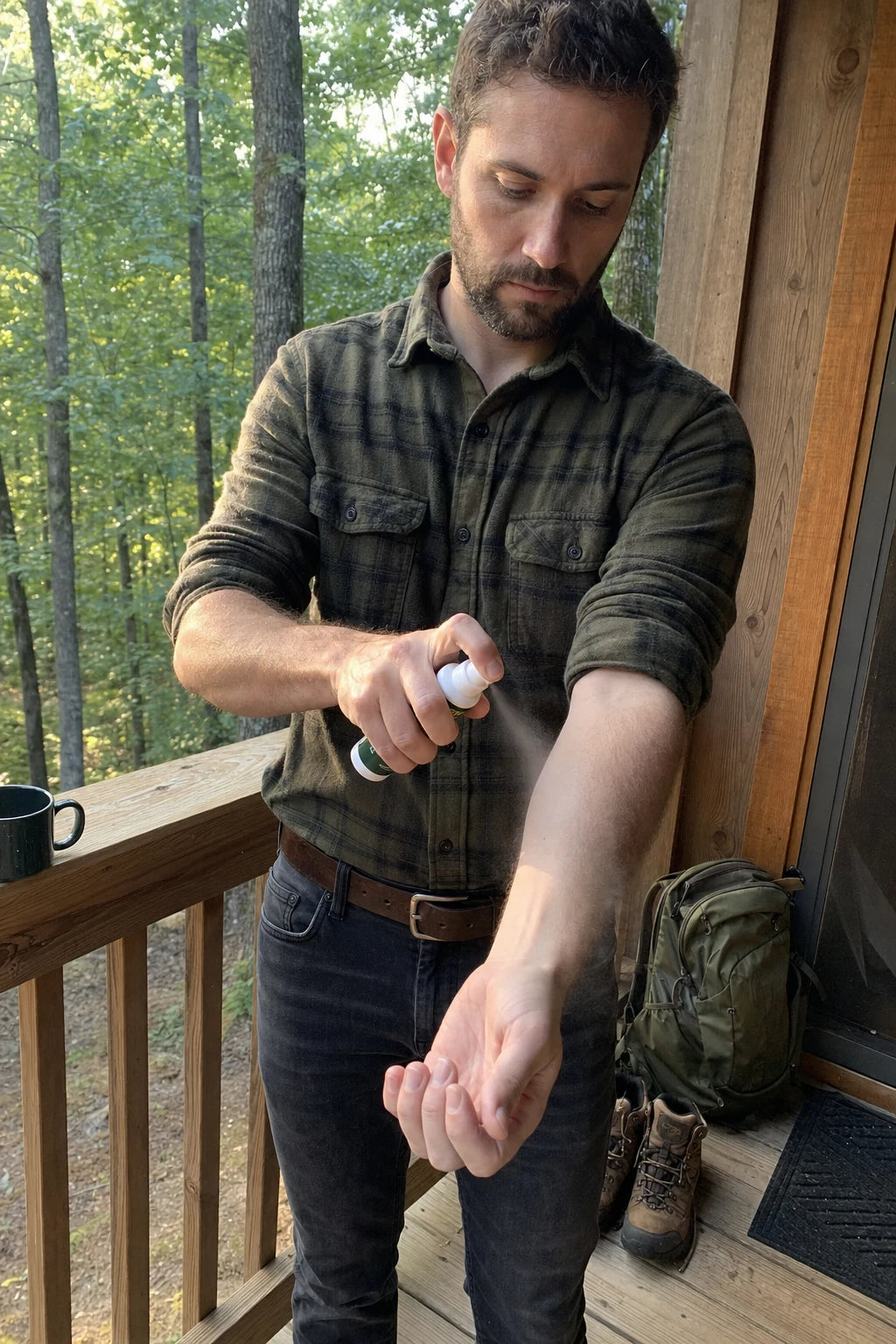 Adult spraying BITEBACK on their forearm before heading out